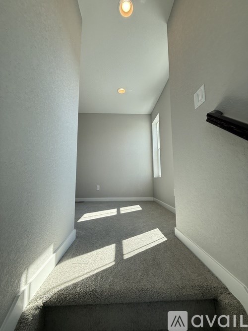 A room with a doorway leading to a storage room.