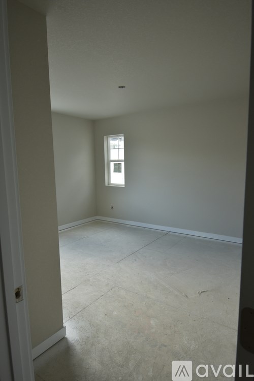 A room with a window and a door.