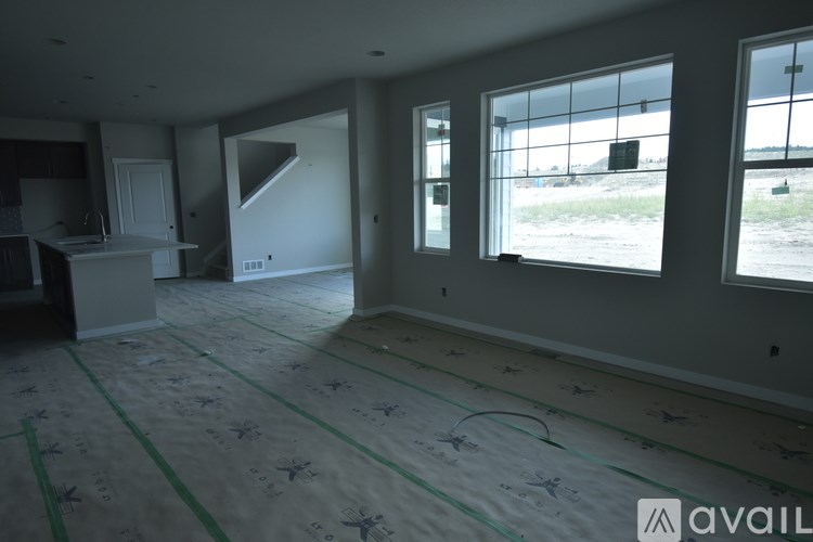 A room with a lot of windows and a staircase.