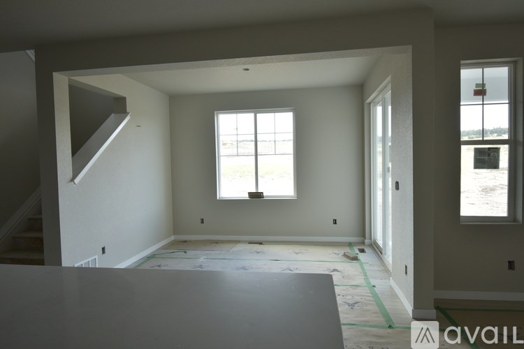 A room with a window and a staircase.