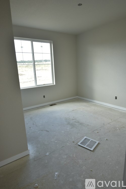 A room with a window and a tile floor.