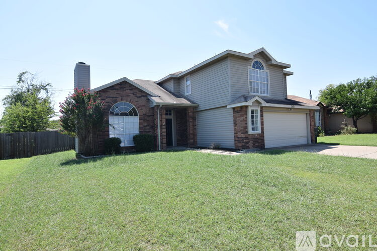 A house with a brown brick front and a white garage door.
