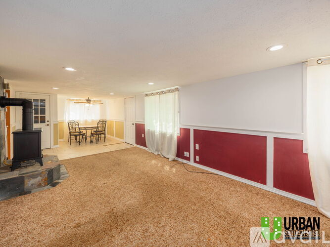 A living room with a fireplace and a dining table.