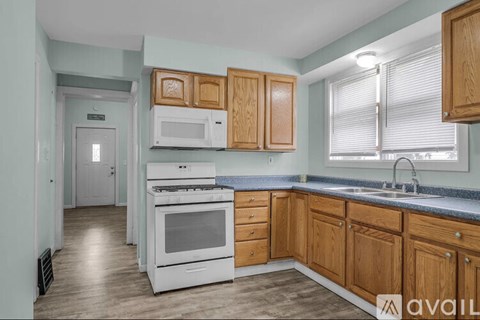 A kitchen with wooden cabinets and a white oven.