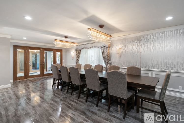 A dining room with a long table and chairs.