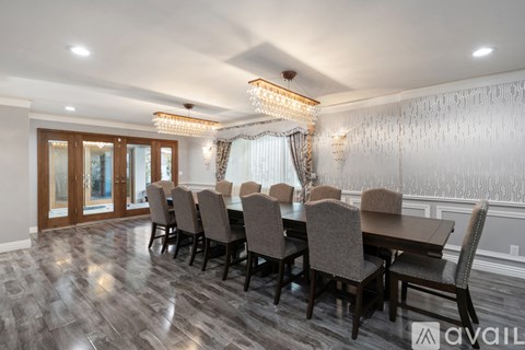 A dining room with a long table and chairs.