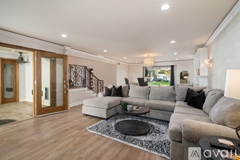 A living room with a grey sofa and a black coffee table.