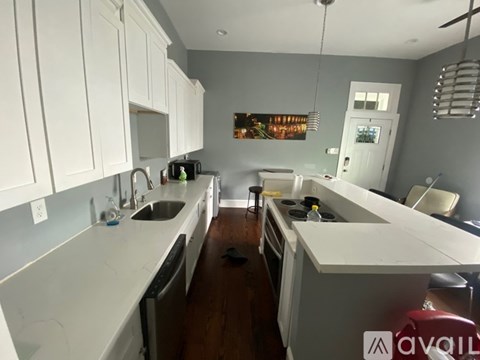 A kitchen with white cabinets and a white countertop.