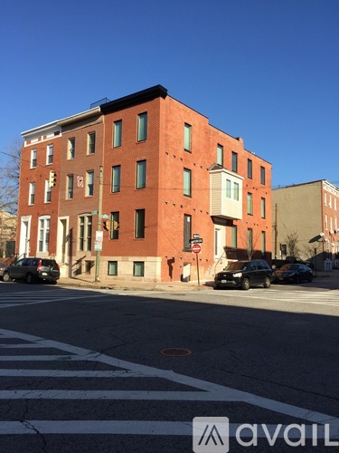 A red brick building with a white awning on the corner.