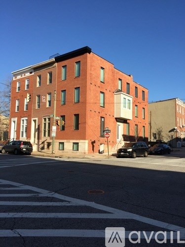 A red brick building with a white awning on the corner.