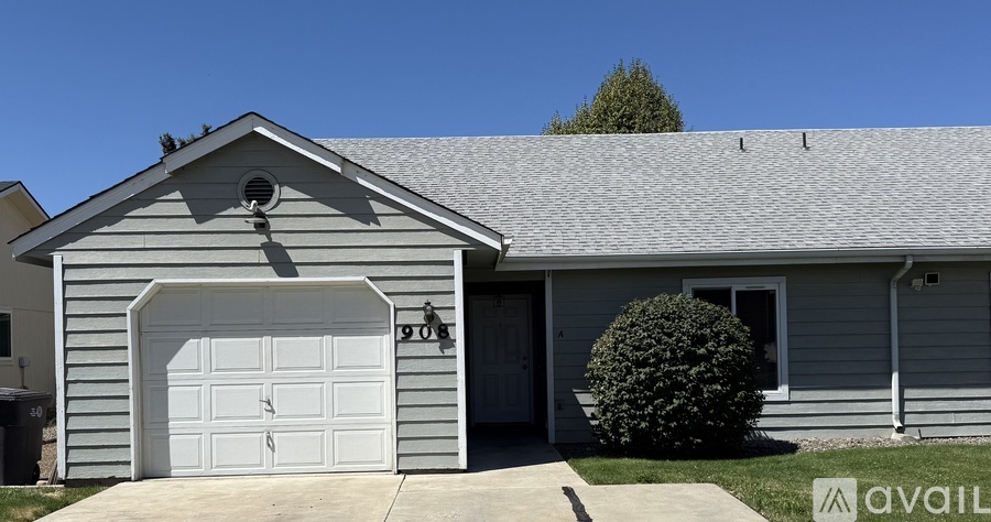 A house with a garage door that has the number 908 on it.