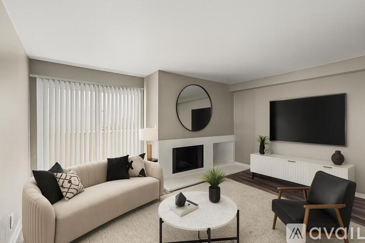 A room with wood flooring and a ceiling fan.