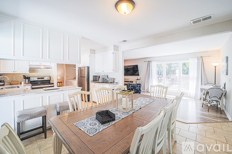 A kitchen with a table and chairs in the foreground.
