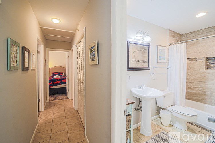 A bathroom with a toilet, sink, and bathtub.