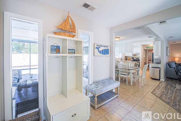 A living room with a white cabinet and a couch.