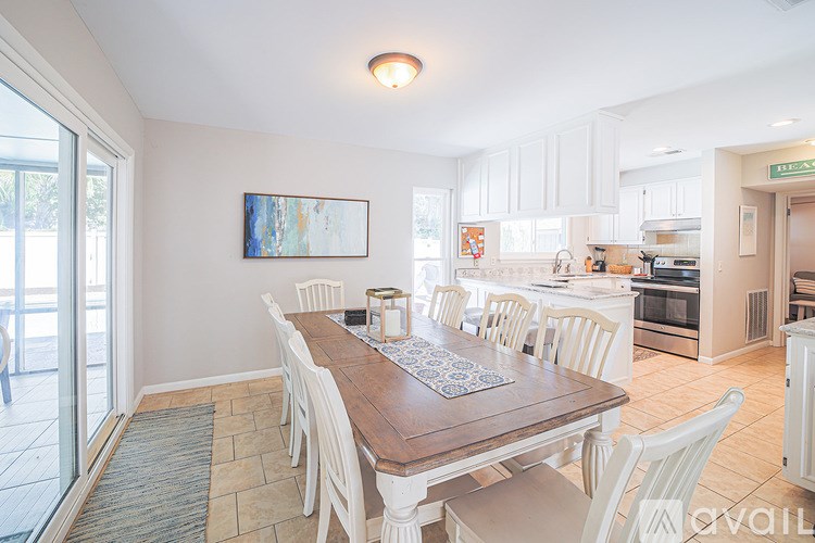A dining room with a wooden table and chairs.