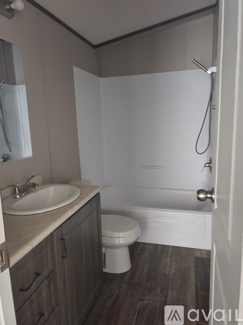 A bathroom with a toilet, sink, and bathtub.