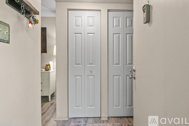 A pair of white doors are closed in a room.
