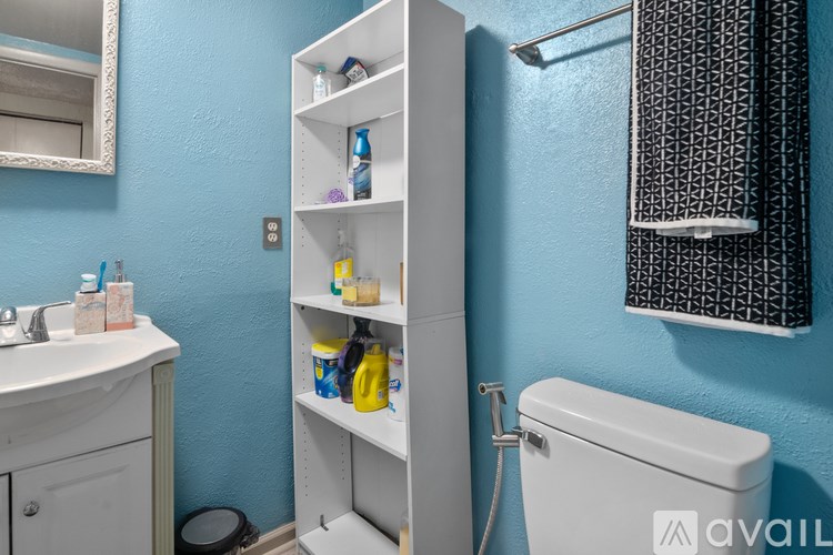 A bathroom with blue walls and a white toilet.