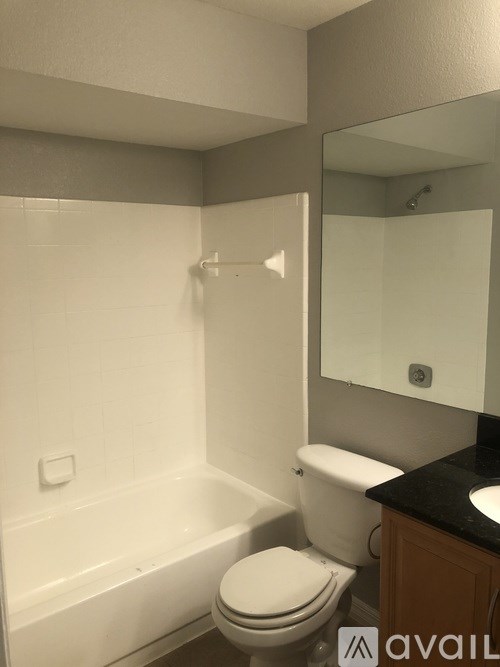 A bathroom with a toilet, sink, and bathtub.