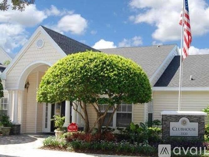A white house with a sign that says "Clubhouse" in front of it.