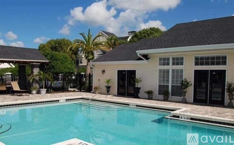 A pool in front of a house with a sign that says "available".