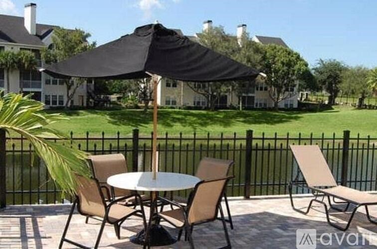 A patio table with chairs and an umbrella is set up on a patio.