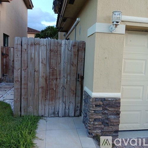 A wooden fence in front of a house.
