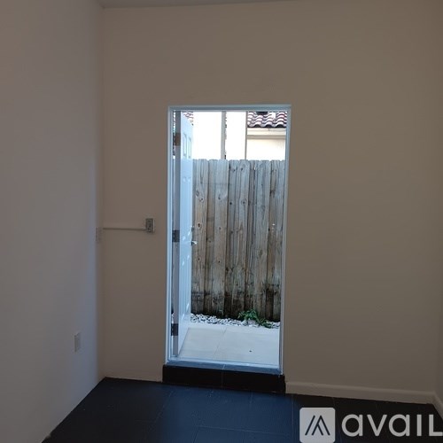 A room with a door leading outside.