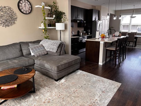 A living room with a grey couch and a coffee table.