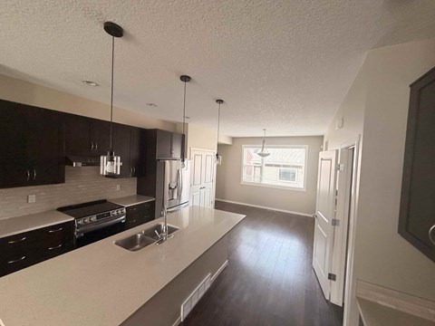 A kitchen with a sink and a window.