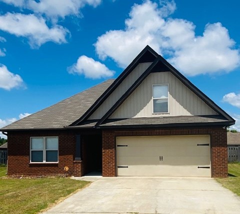 A house with a garage door and a window.