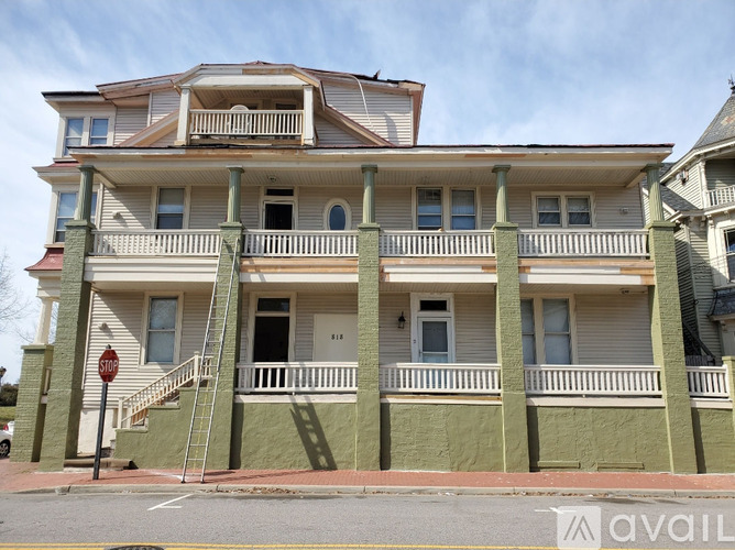 A two-story house with a balcony on the second floor.