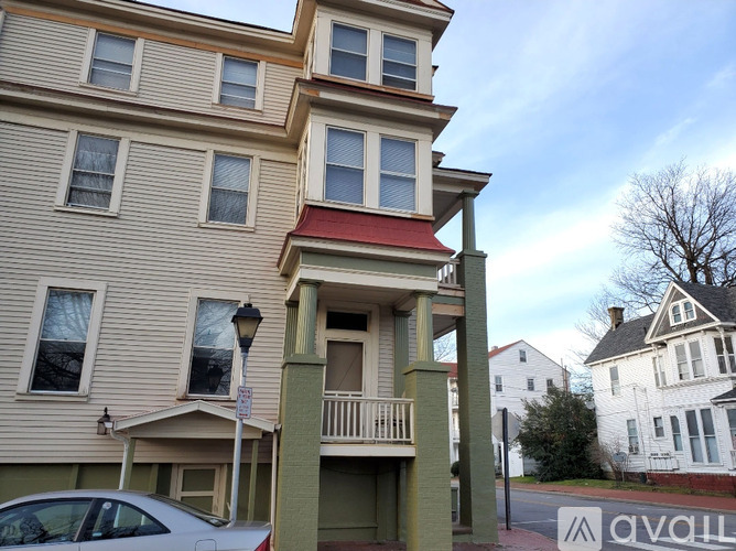 A two story building with a balcony on the second story.
