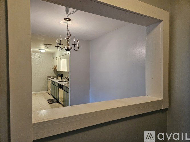 A bathroom with a mirror and a chandelier.