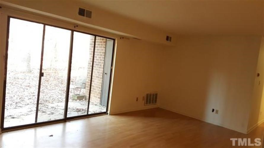 A room with a sliding glass door leading to a snowy outdoor area.