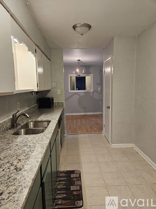 A kitchen with granite countertops and a sink.