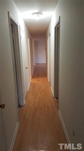 A long hallway with doors on both sides.