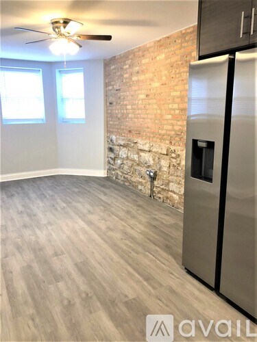 A room with a brick wall and a wooden floor.