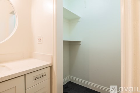 A bathroom with a sink and a mirror.