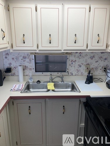 A kitchen with a sink and cabinets.