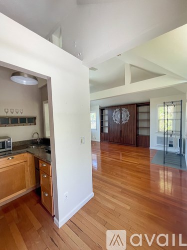 A kitchen with wooden floors and a counter top.