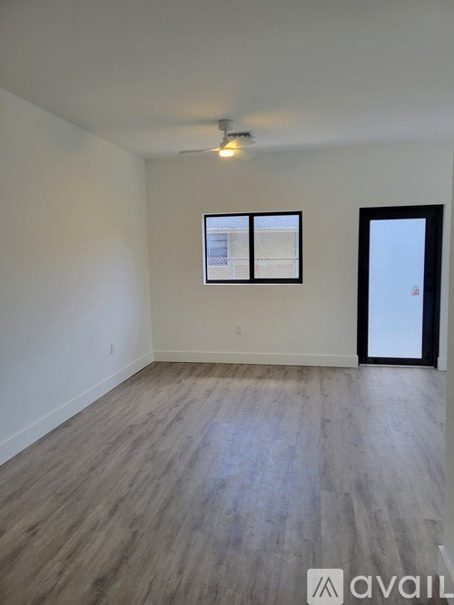 A room with a ceiling fan and a window.