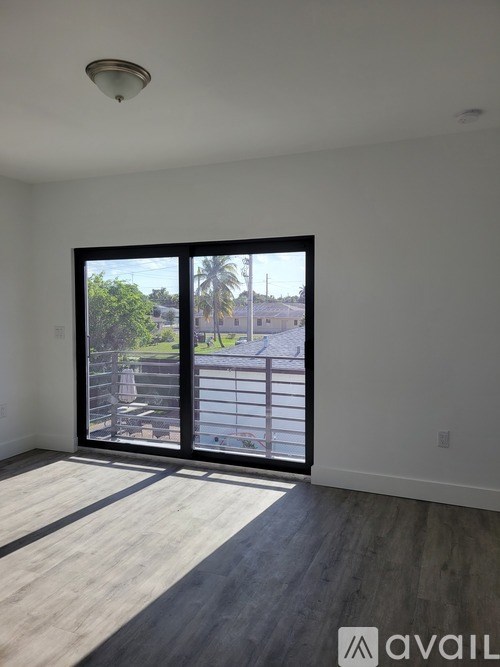 A room with a large window overlooking a parking lot.