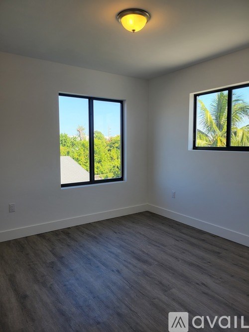 A room with a large window and a smaller window on the wall.