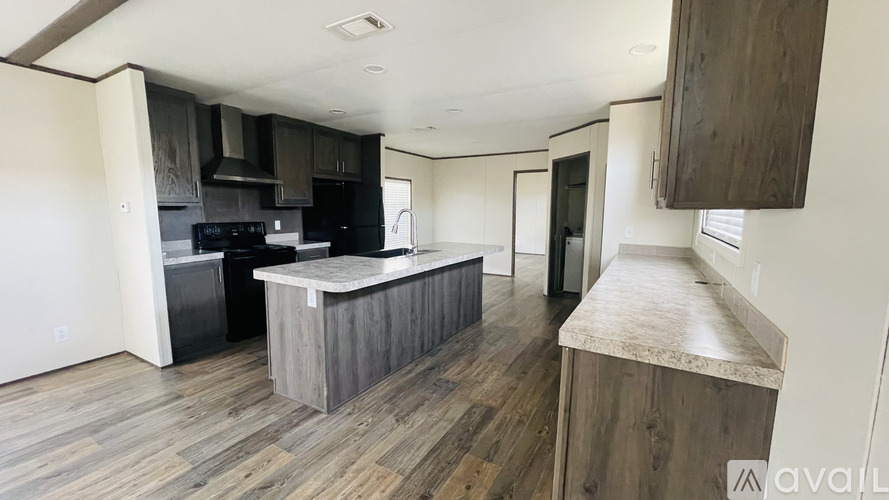 A kitchen with a wooden floor and a counter.