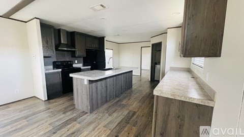 A kitchen with a wooden floor and a counter.