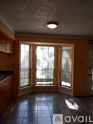 A room with brown cabinets and a tiled floor.