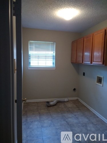 A room with a window and a pipe on the floor.