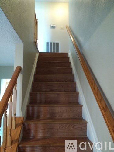 A staircase with wooden steps and a railing.